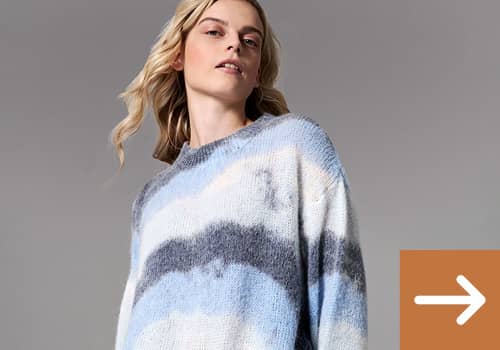 Frau mit Strickpullover in hellblau und weiß