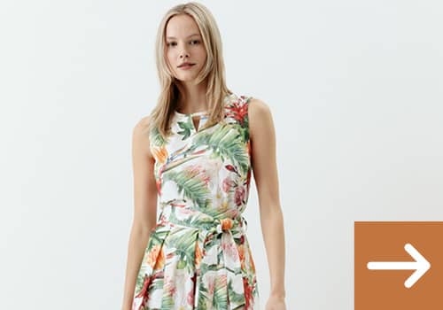 Frau trägt ein langes Sommerkleid mit sehr modischem floralen Druck.